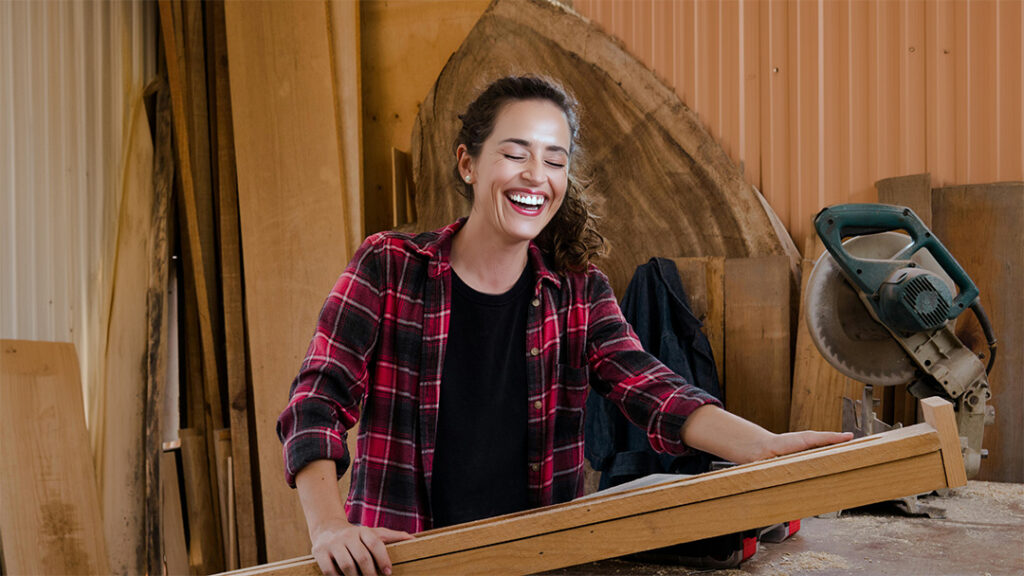 woman laughing inside R&B Solutions metal building workshop