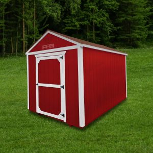 A photo of a red siding and white trim wood shed with one single barn door on concrete blocking.